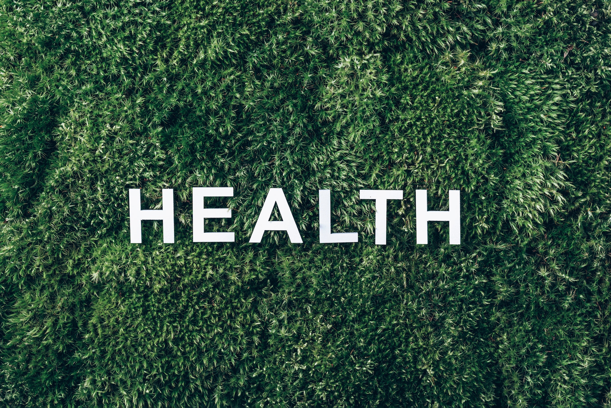 Word Health on moss, green grass background. Mental Health concept